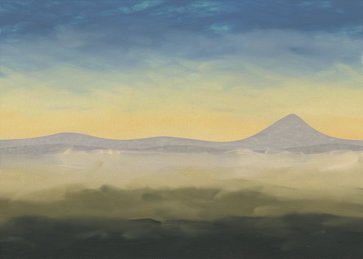 Distant mountains above mist and a dark foreground beneath evening light.